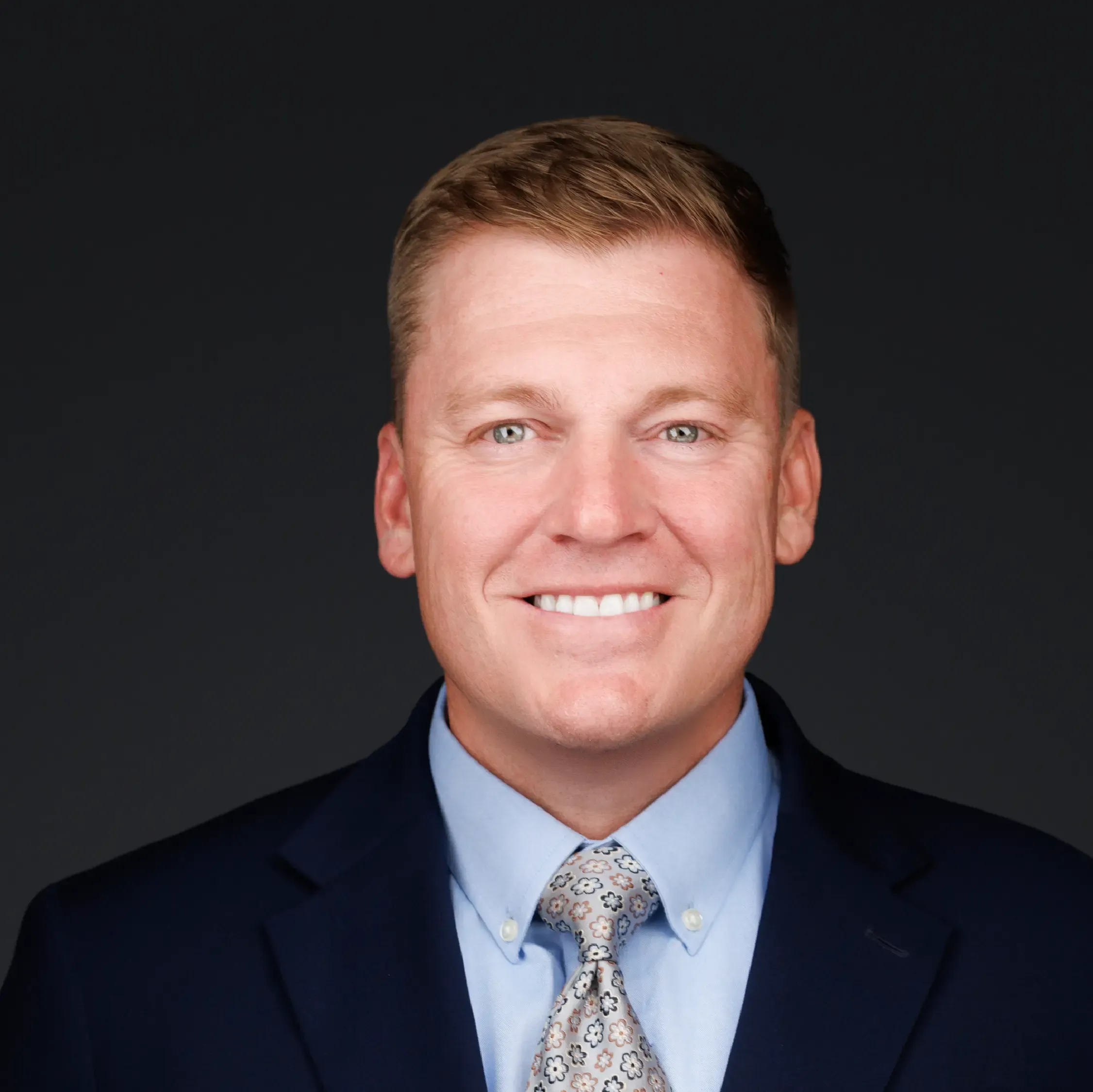 a man in a suit smiling
