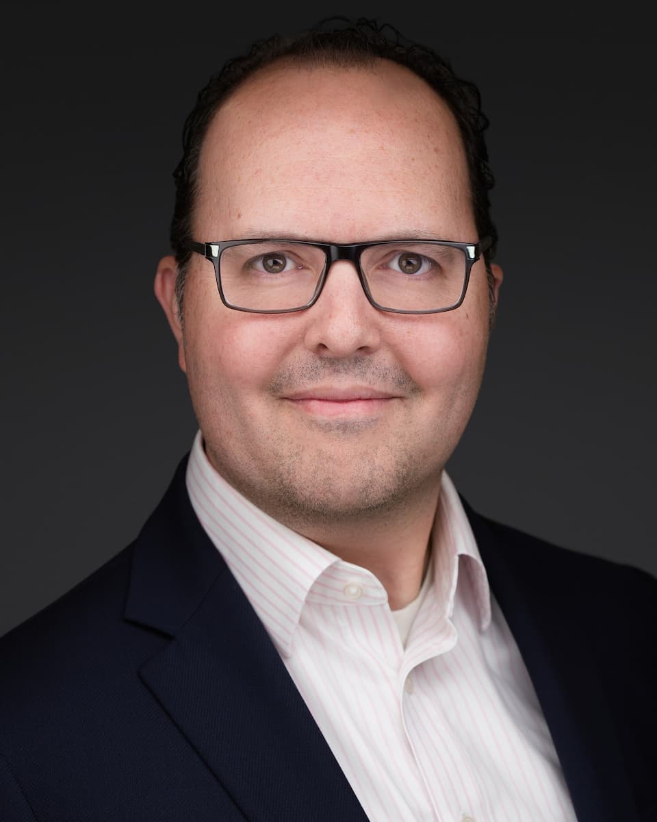 a man in a suit and glasses