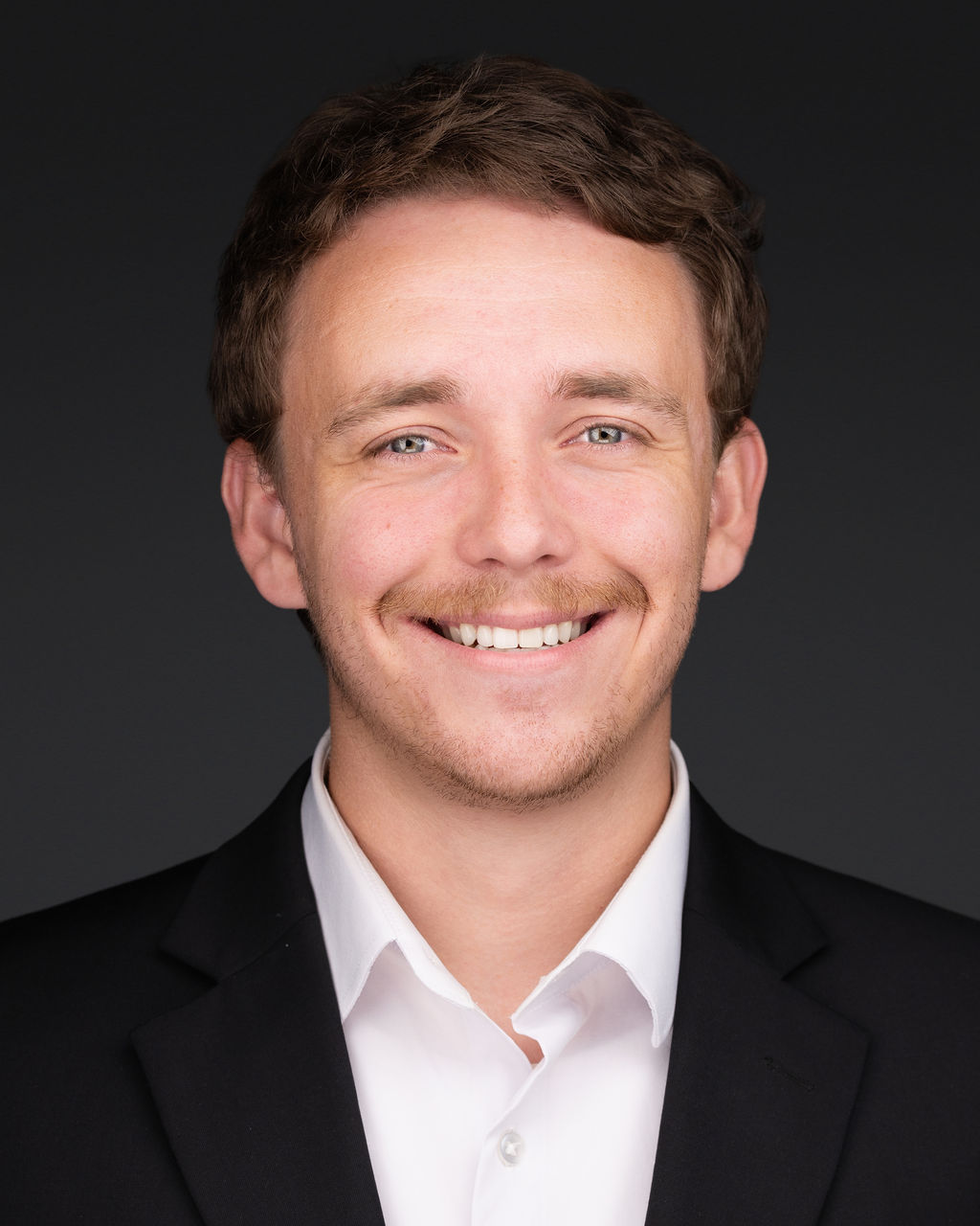 a man in a suit smiling