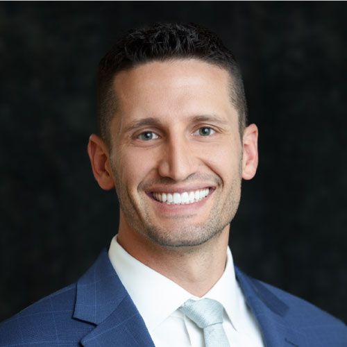 a man in a suit smiling